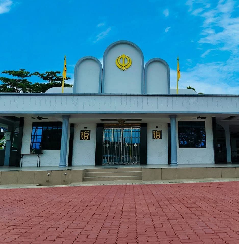 The Gurdwara's exterior with the Nishan Sahib flag